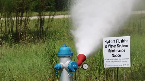 Car Passes in Front of Flushing Fire Hydrant Stock Footage 52888591