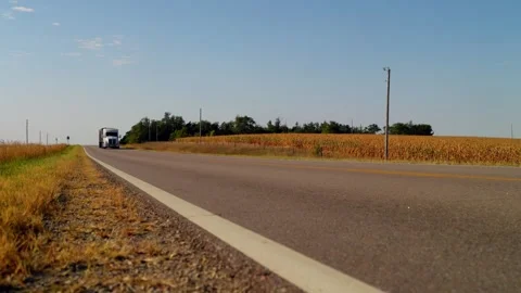 A car passes on a rural two-lane highway on the plains Stock-Footage 345531012