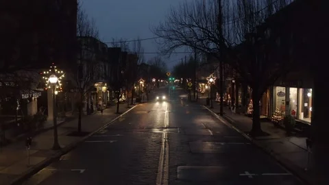 Car passes through quiet town at night, decorated with Christmas stars and Stock Footage 152653798