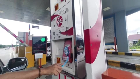  A car passes the toll gate. The driver makes toll payments with a toll card. Stock Footage 245287066