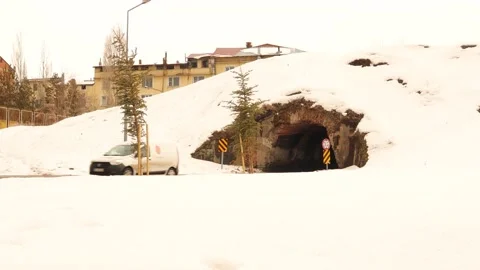 Car passes under an ancient snow-covered bridge. winter scene in the city Stock Footage 150455128