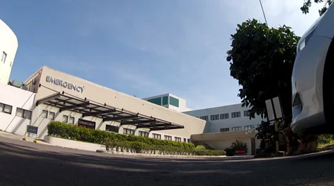 Car passing accross the camera at the Emergency facility of a Medical Center Stock Footage