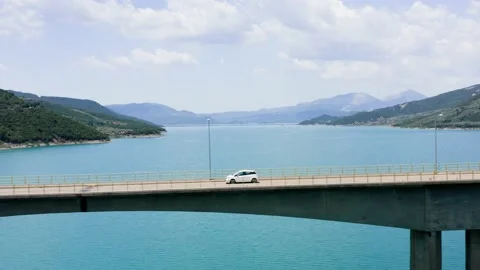 Car passing bridge over lake. Stock Footage 201021087