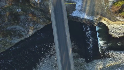 Car passing bridge over mountain river in topdown view. Aerial. Static. Stock Footage 147628069