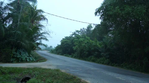 A Car Passing By On Cornering Road In Malaysian village Stock Footage 34731164
