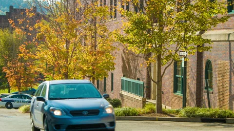 Car Passing Fall Colored Tree-lined Street at Asheville Police Station Stock Footage 33058323