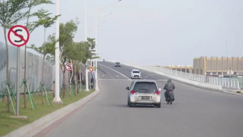 Car passing over the bridge in a cloudy windy day with No Stop sight Stock Footage 156991196