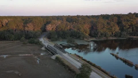 Car passing over a bridge in the forest road Stock Footage 153800876