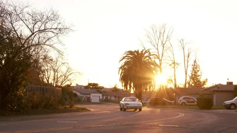 A car passing on the road against the background of a golden sunset Stock Footage 197814925