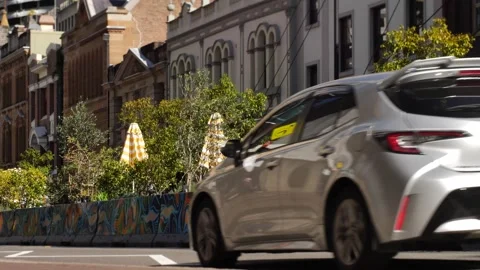 Car passing the Rocks eatery reflection slow motion 4K Stock Footage 201444833