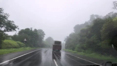 Car passing though a tropical forest on a rainy day in the Western ghat Stock Footage 322526189