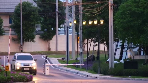 Car passing through automatic barrier at the entrance of private village Video stock 158753558