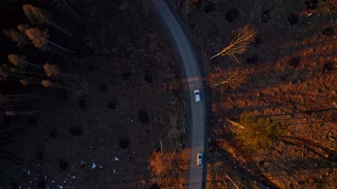 Car passing through a deserted area at sunset Stockbeeldmateriaal 170543916