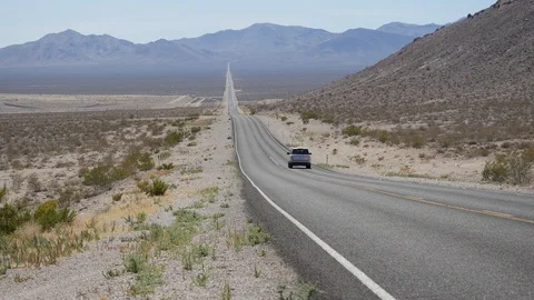 Car passing through Nevada desert Stock Footage 95486723
