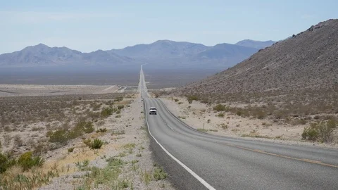 Car passing through Nevada desert Stock Footage 95487285
