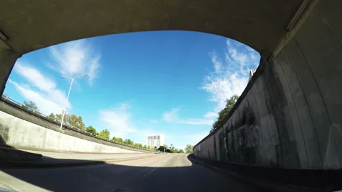 Car passing under bridge on an underpass on a motorway Video stock 153356594