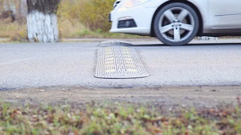 Car path through a speed bump. Speed limit on the road.Traffic Laws. Stock Footage 119105208