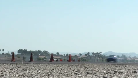 A car performs a drifting maneuver on a test track. Stock Footage 107478360