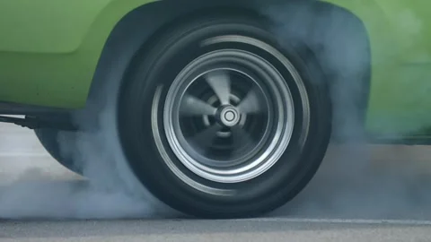 Car performs tire burnout in parking lot Stock Footage 311944217