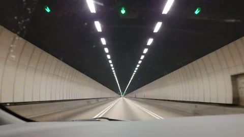 Car perspective driving through a modern lit road tunnel in Hong Kong. Stock Footage 325018916