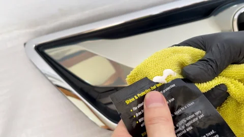 Car plastic dressing being squeezed on towel Stock Footage 311677929