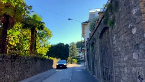 Car Point of View in City of Melide with Lake and Mountain in a Sunny Day Stockbeeldmateriaal 220677279