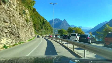 Car Point of View on Mountain Road with Alpine Lake Lugano in a Sunny Day 스톡 동영상 191952603