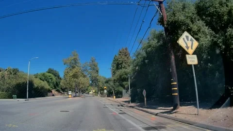 Car point of view of a suburban road past green hillsides, Los Angeles #2 Stock Footage 343475718