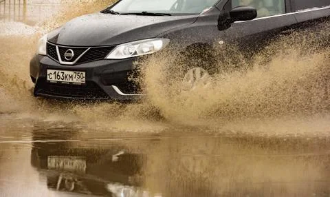 Car in a pool of water with splashes Fotos Stock