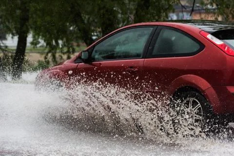 Car in a pool of water with splashes 写真素材