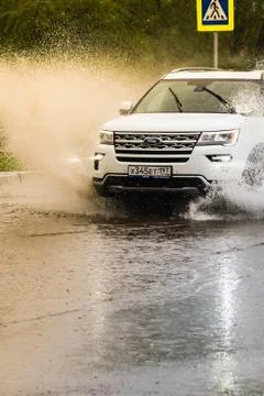 Car in a pool of water with splashes Фото
