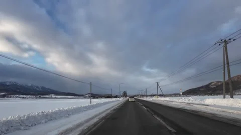 Car POV Driving On Empty Straight Snowy Road In Rural Furano Hokkaido Japan Vídeos de archivo 333699023