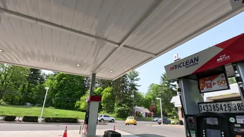 Car POV pulling into refuel at a Citgo Gas-Station by a busy road Stock Footage 242850488