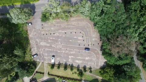 Car practicing maneuvers on driving school test track from an aerial view 스톡 동영상 347864939