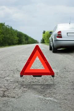 Car with problems and a red triangle to warn other road users Stock Photos