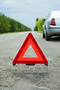 Car with problems and a red triangle to warn other road users Stock Photos