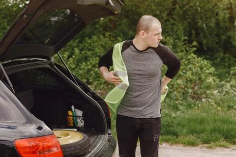 Car with problems and a red triangle to warn other road users Stock Photos