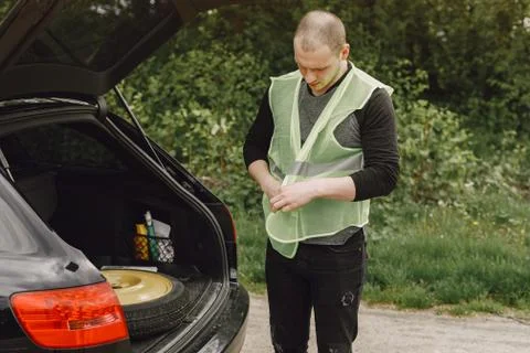 Car with problems and a red triangle to warn other road users Stock Photos