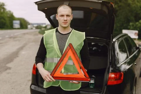 Car with problems and a red triangle to warn other road users Stock Photos