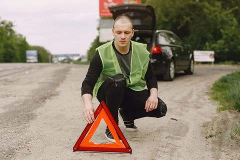 Car with problems and a red triangle to warn other road users Stock Photos