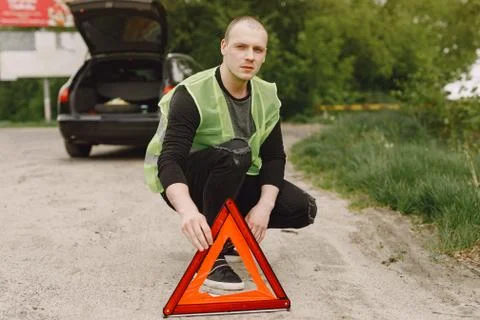 Car with problems and a red triangle to warn other road users Stock Photos