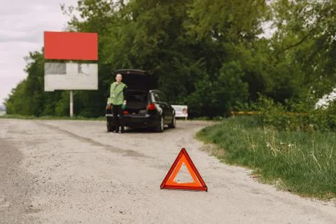 Car with problems and a red triangle to warn other road users Stock Photos