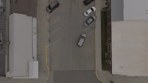 Car Pulling out of Angled Parking Space Aerial 2.7k Stock Footage 145562318