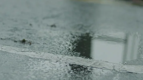 CAR PULLING UP INTO PUDDLE Stock Footage 141062547