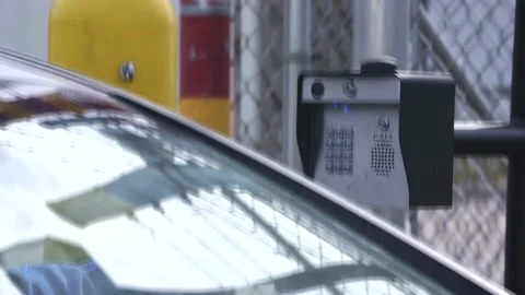 Car pulling up to a security keypad Stock Footage 194210202