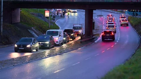 Car queue at an underpass in rainy weather Stock Footage 305929966