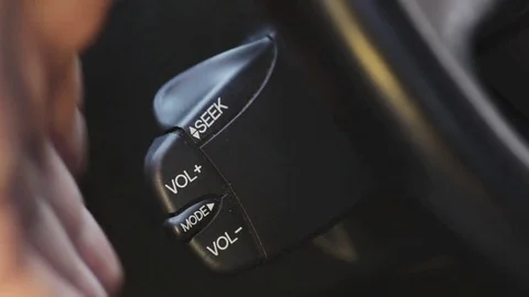 Car quick control volume buttons on steering wheel Stock Footage 69942166