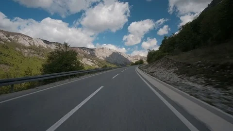 Car quickly rides along asphalt road in countryside in summer day outdoor along Stock Footage 78934136