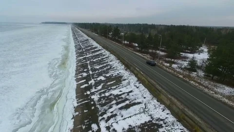 The car quickly rides along the empty highway in winter. Aerial view. Stock-Footage 72510324