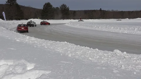 Car racing on slippery ice and snow track on nice cold winter day Stock Footage 103126540